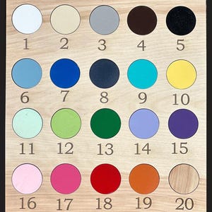 May include: Wooden color chart with twenty circular color samples. The colors include white, beige, gray, brown, black, light blue, blue, navy, teal, yellow, mint, green, dark green, lavender, purple, pink, magenta, red, orange, and wood.