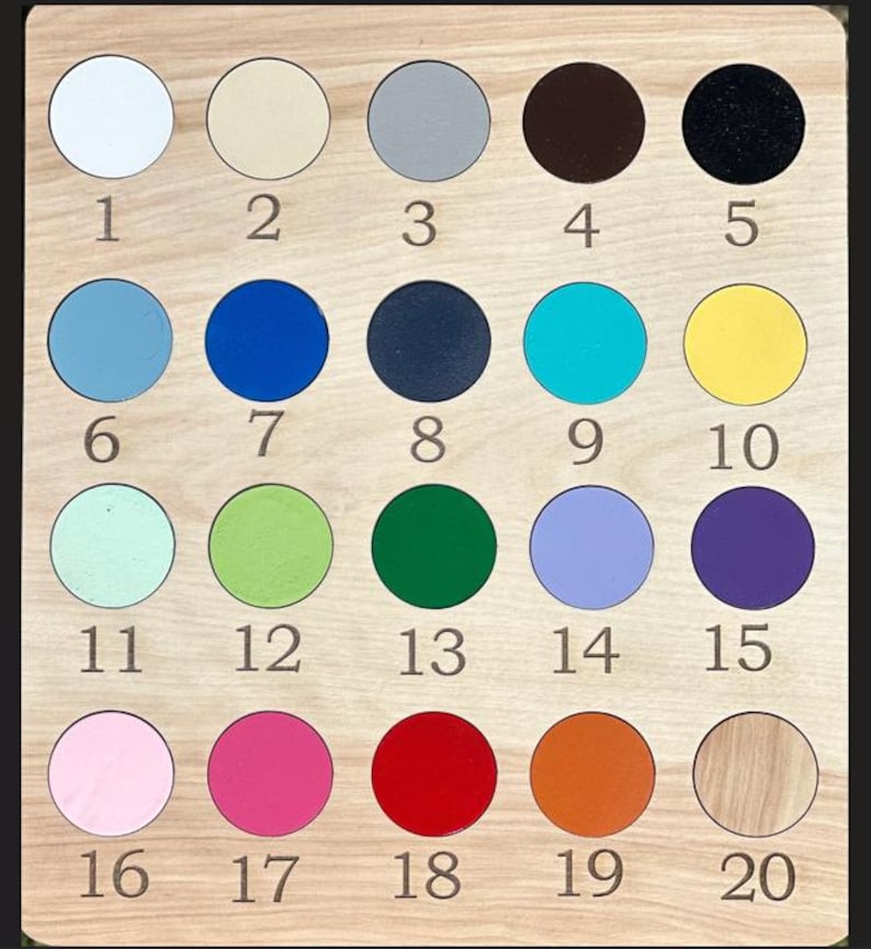 May include: Wooden color chart with twenty circular color samples. The colors include white, beige, gray, brown, black, light blue, blue, navy, teal, yellow, mint, green, dark green, lavender, purple, pink, magenta, red, orange, and wood.