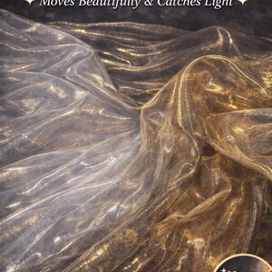 May include: A close-up of shimmering, flowing fabric in shades of silver and gold. The text on the image reads "LIGHTWEIGHT & FLOWING" and "Ultra Reflective Sheer Metallic Chiffon". The fabric catches the light, creating a beautiful, reflective effect.