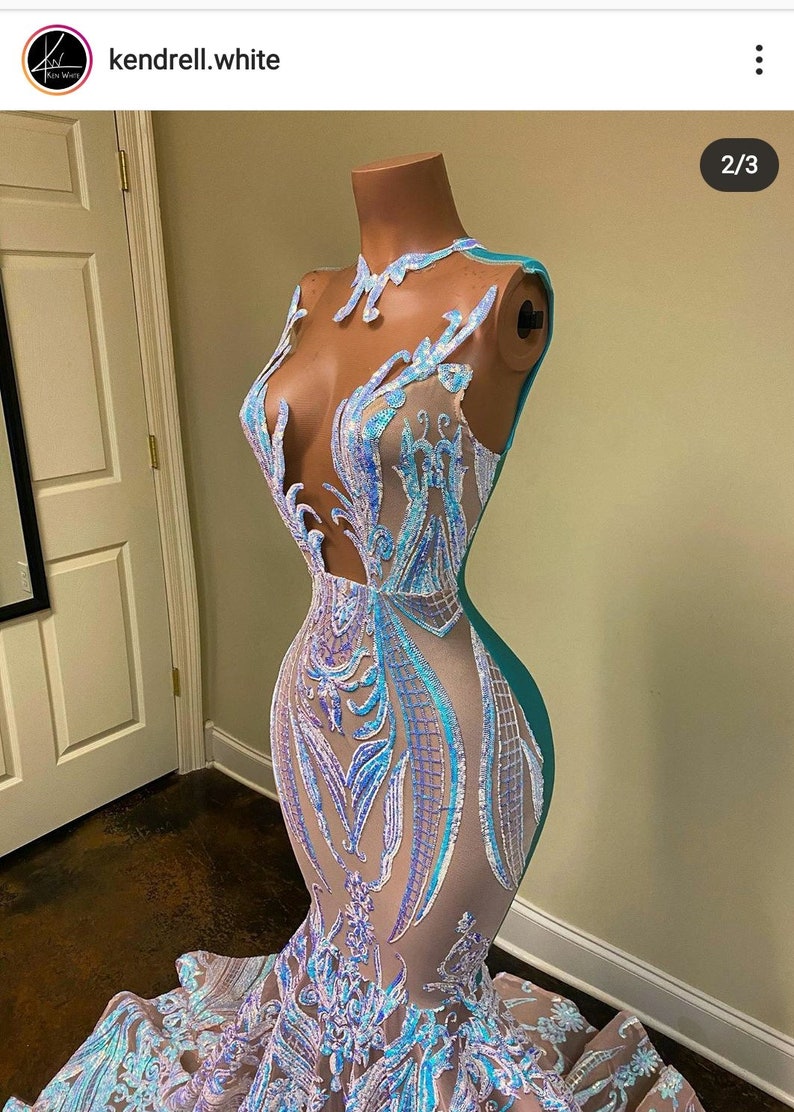 May include: A mermaid-style gown with a sheer bodice and a teal skirt. The bodice is covered in iridescent sequins and features a floral design. The skirt is made of a smooth fabric and flows to the floor.