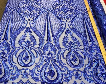 May include: Royal blue sequined fabric with a damask pattern. The fabric is sheer and has a delicate, intricate design.