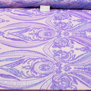 May include: Purple iridescent sequins on a light pink fabric with a damask pattern.