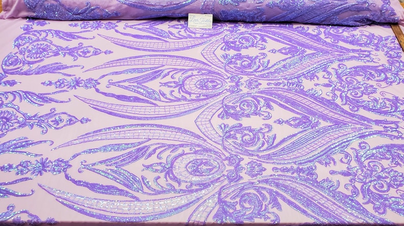 May include: Purple iridescent sequins on a light pink fabric with a damask pattern.
