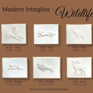 May include: Six white ceramic tiles with raised images of various animals, including a hare, fox, bear, rabbit, buffalo, and deer. Each tile has a gold border and a label with the animal's name and dimensions in inches.