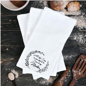 May include: White kitchen towels with a black floral wreath and the text "All that I am or ever hope to be, I owe to my Mother".