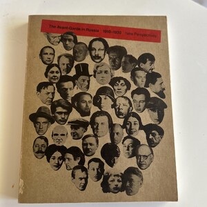 May include: A white ceramic mug with a black handle and the text "But First, Coffee" in a bold, black font. The mug is sitting on a wooden surface. The mug is approximately 4 inches tall.