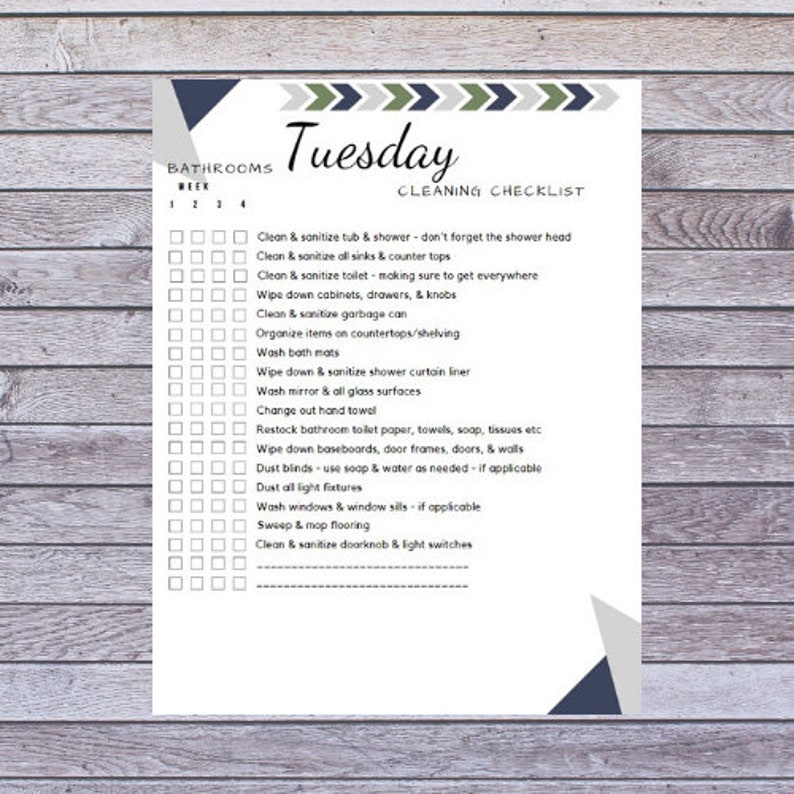 May include: A white cleaning checklist titled "Tuesday Cleaning Checklist" with a wooden background. The checklist includes tasks like cleaning the tub, sinks, toilet, and other bathroom surfaces. Decorative geometric shapes in blue, green, and gray are at the top and bottom.