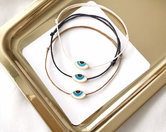 Vergulde armband met boze oog, verstelbare macramé-bedel