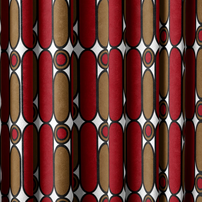 May include: Red and brown geometric pattern fabric with a white background. The pattern features repeating oval shapes with a circle inside.
