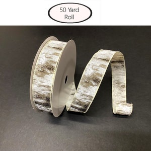 May include: A 50 yard roll of white and brown birch bark patterned ribbon. The ribbon is on a spool and is curled to show the pattern.
