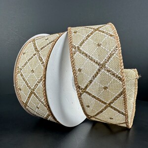 May include: A roll of beige and gold wired ribbon with a diamond pattern. The ribbon is made of burlap and has a shimmery gold finish.
