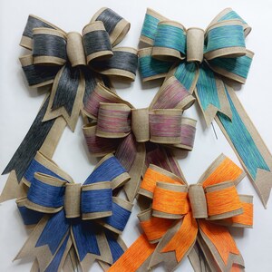 May include: Six burlap bows with different colored ribbon. The bows are tied with a loop and have a long tail. The colors of the ribbon are black, teal, purple, blue, orange, and a mix of pink and purple.
