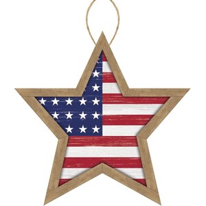 May include: Wooden star-shaped decoration featuring the American flag design. The star has a natural wood frame and a rustic, distressed finish. The flag design includes red and white stripes and a blue field with white stars. A jute string is attached for hanging.