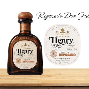 May include: A bottle of Reposado Don Julio tequila with a wooden cap and a label that reads "Henry" and "Reposado". A separate label is also visible, with the text "Will you be my groomsman? Henry".