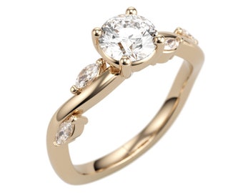 May include: A gold engagement ring featuring a large round centre diamond and smaller pear-shaped diamonds on the band.