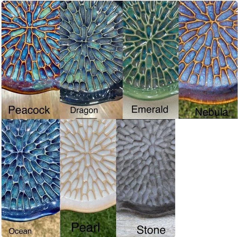 May include: A collection of seven circular ceramic plates featuring a radial, honeycomb-like texture. The color variations include Peacock, Dragon, Emerald, Nebula, Ocean, Pearl, and Stone, each labeled with its respective name below the plate.