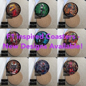 Könnte beinhalten: Neun F1-inspirierte Untersetzer mit Fahrerillustrationen. Jeder Untersetzer hat einen schwarzen Rand und steht auf einer runden Korkbasis. Der Text "F1 Inspired Coasters - New Designs Available!" ist enthalten.