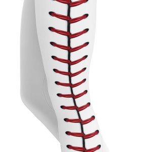 May include: White leggings with a baseball-inspired design. The leggings feature a red and black stitch pattern down the side, mimicking the seams of a baseball. The design is printed on the side of the leggings.