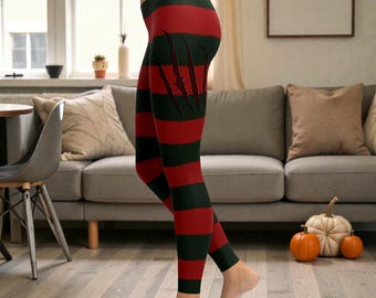 May include: Red and black striped leggings with claw marks. The leggings have horizontal stripes in red and black, with claw marks on the side. The leggings are made of a stretchy material.