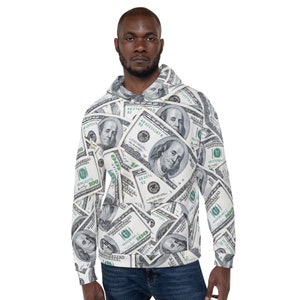 May include: A hooded sweatshirt with a repeating pattern of $100 bills. The design includes portraits of Benjamin Franklin and the text "100". The sweatshirt is white, green, and black.