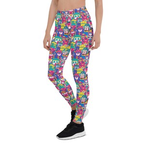 May include: Vibrant leggings with a repeating pattern of colorful cartoon characters in shades of blue, pink, yellow, and green. The leggings are form-fitting and made of a stretchy material, suitable for athletic activities or casual wear.