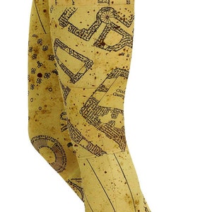 May include: Leggings with a vintage map design in shades of tan and brown. The leggings feature a detailed map print with text and architectural elements, creating a unique and stylish look. The leggings are form-fitting.