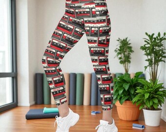 May include: High-waisted leggings featuring an all-over print of vintage cassette tapes in black, white, and red. The pattern displays multiple cassette designs with text labels including New Wave, Punk, and Rock & Roll, paired with white trainers.