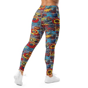 May include: Vibrant leggings featuring a comic book-style print. The design incorporates panels with action scenes, red roses, and the words "BOOM!" and "ZAP!" in bold lettering. The leggings are primarily blue, red, and yellow.