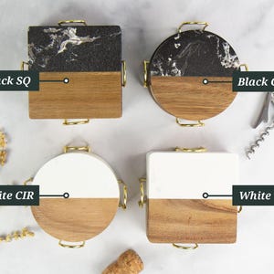 May include: Four coasters with gold handles, each with a different design. Two are square and two are round. The top halves are black and white marble, and the bottom halves are wood. The other two are white and wood. Text on the image says "Black SQ", "Black CIR", "White CIR", and "White SQ".