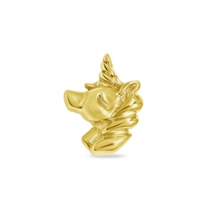 May include: A gold-coloured unicorn charm with a closed eye and a detailed mane.