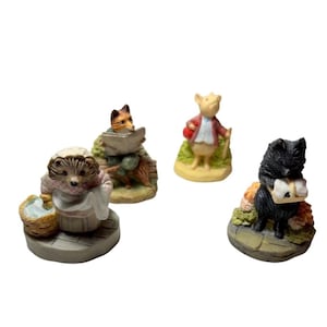 May include: Four miniature figurines of woodland creatures. A hedgehog with a basket, a fox reading a paper, a pig with a walking stick, and a black cat carrying a package. Each figurine is detailed and colorful.