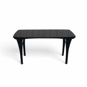 May include: A black rectangular table with a glossy finish and four unique, curved legs.