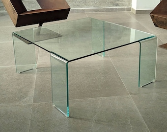 Curved glass coffee table designed by Rodolfo Dordoni