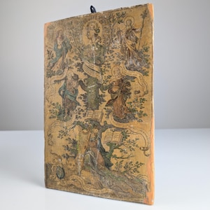 May include: A vintage, hand-painted wooden panel depicting a tree of life with multiple figures and text. The figures are painted in shades of brown, green, and yellow, and the background is a light yellow. The panel has a hanging loop at the top.
