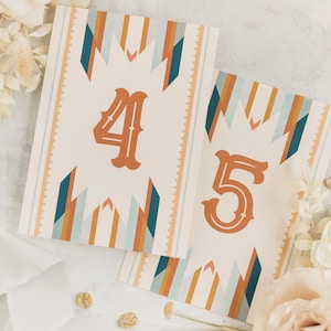 May include: Two table number cards with a geometric pattern in shades of orange, blue, and white. The numbers 4 and 5 are printed in a bold orange font.