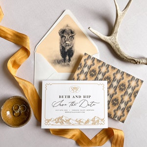May include: Save the date card with a gold and black design. The card features a mountain range, a buffalo, and the text "Beth and Rip Save the Date July 4th, 2022 Paradise Valley, Montana www.bethlovesrip.com".