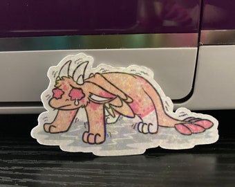 May include: A pink and orange cartoon dragon with a sad expression. The dragon has large, red eyes with tears coming out of them. The dragon is standing on a light blue surface with a white background.