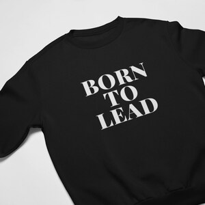 May include: Black sweatshirt with white text that reads "Born to Lead".
