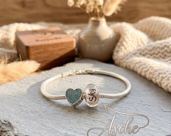 Sterling silver bracelet with a personalized bead bearing your pet's name, made from their own fur. Pet hair jewelry, keepsake, ashes, fur.