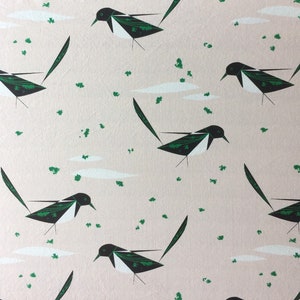 May include: A seamless pattern featuring black and white stylized magpies on a light pink background. The magpies are repeated throughout the pattern and are facing different directions. The background is a light pink color with a subtle texture.