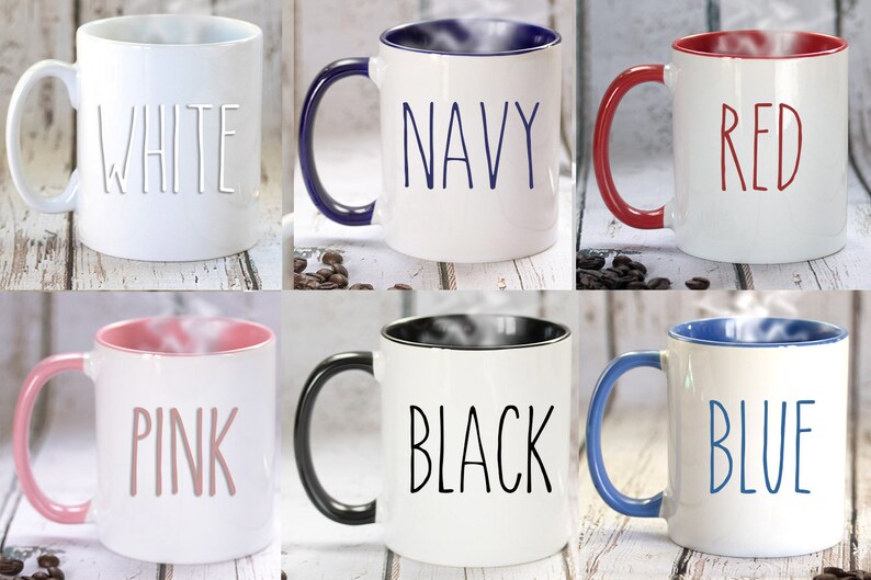 May include: Six ceramic coffee mugs with different colored rims. The mugs are white with the words "WHITE", "NAVY", "RED", "PINK", "BLACK", and "BLUE" written in black on the front of each mug.