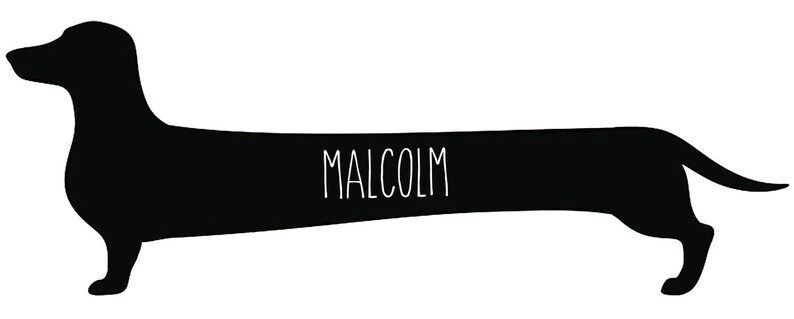 May include: A black silhouette of a dachshund dog with the name "MALCOLM" in white, centered on the dog's body. The dog is in a standing position, with its legs visible and tail slightly curved. The background is plain white.