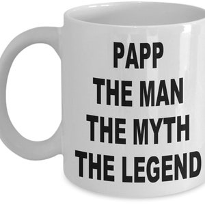 May include: White ceramic mug with the text "PAPP THE MAN THE MYTH THE LEGEND" in bold black letters. The mug has a curved handle and a cylindrical shape, suitable for hot beverages.