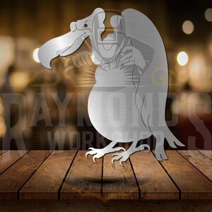 May include: A metal cutout of a stylized vulture with a brushed silver finish. The vulture is perched with its wings folded and its head turned to the side.