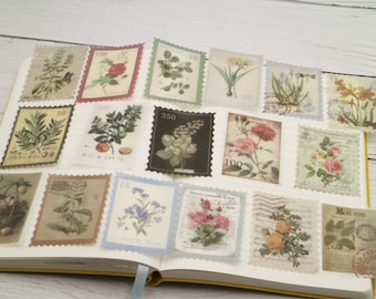 May include: A collection of vintage-style floral and botanical postage stamp stickers. The stickers feature various flowers, plants, and illustrations, with muted colors and aged paper effects. They are arranged on an open notebook.