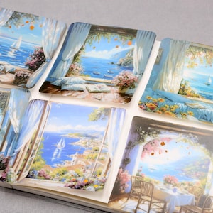 May include: A collection of stickers featuring scenic views of the ocean and coastal landscapes. Each sticker showcases a different window view with blue skies, sailboats, and colorful flowers. The stickers are arranged in a notebook.