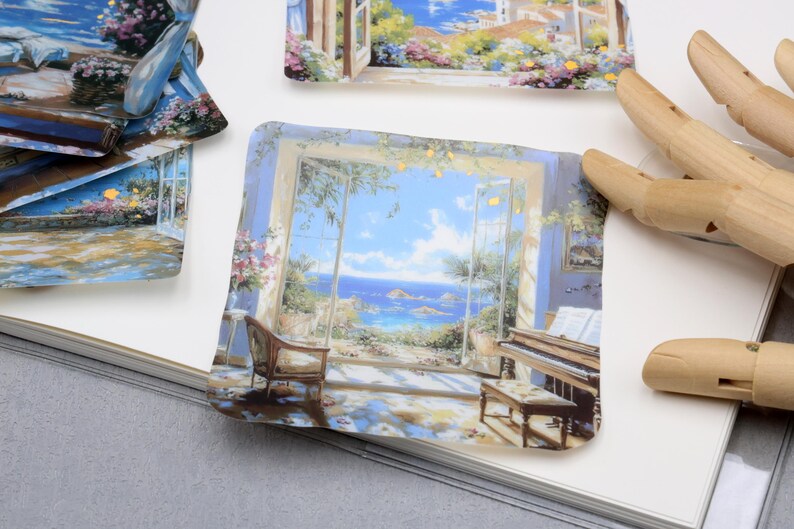 May include: A collection of square stickers featuring scenic paintings. One sticker depicts a room with a piano and a view of the ocean. Other stickers show similar scenes of landscapes and architecture, with a focus on light and color.