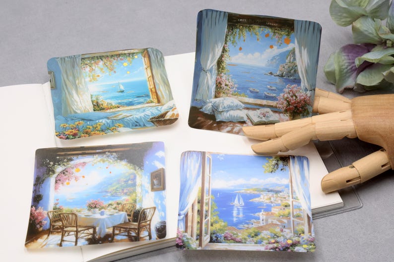 May include: Four square decorative coasters featuring scenic coastal views. Each coaster depicts a different window scene with ocean views, sailboats, and floral accents. The color palette includes blues, whites, and greens, evoking a serene atmosphere.
