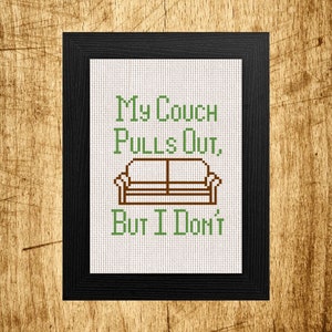 May include: A framed cross-stitch design with a green and brown couch and the text "My Couch Pulls Out, But I Don't".