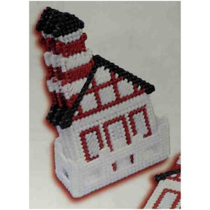 May include: A white, red and black crocheted lighthouse with a black roof and white base. The lighthouse has a red and white striped tower with a black top.